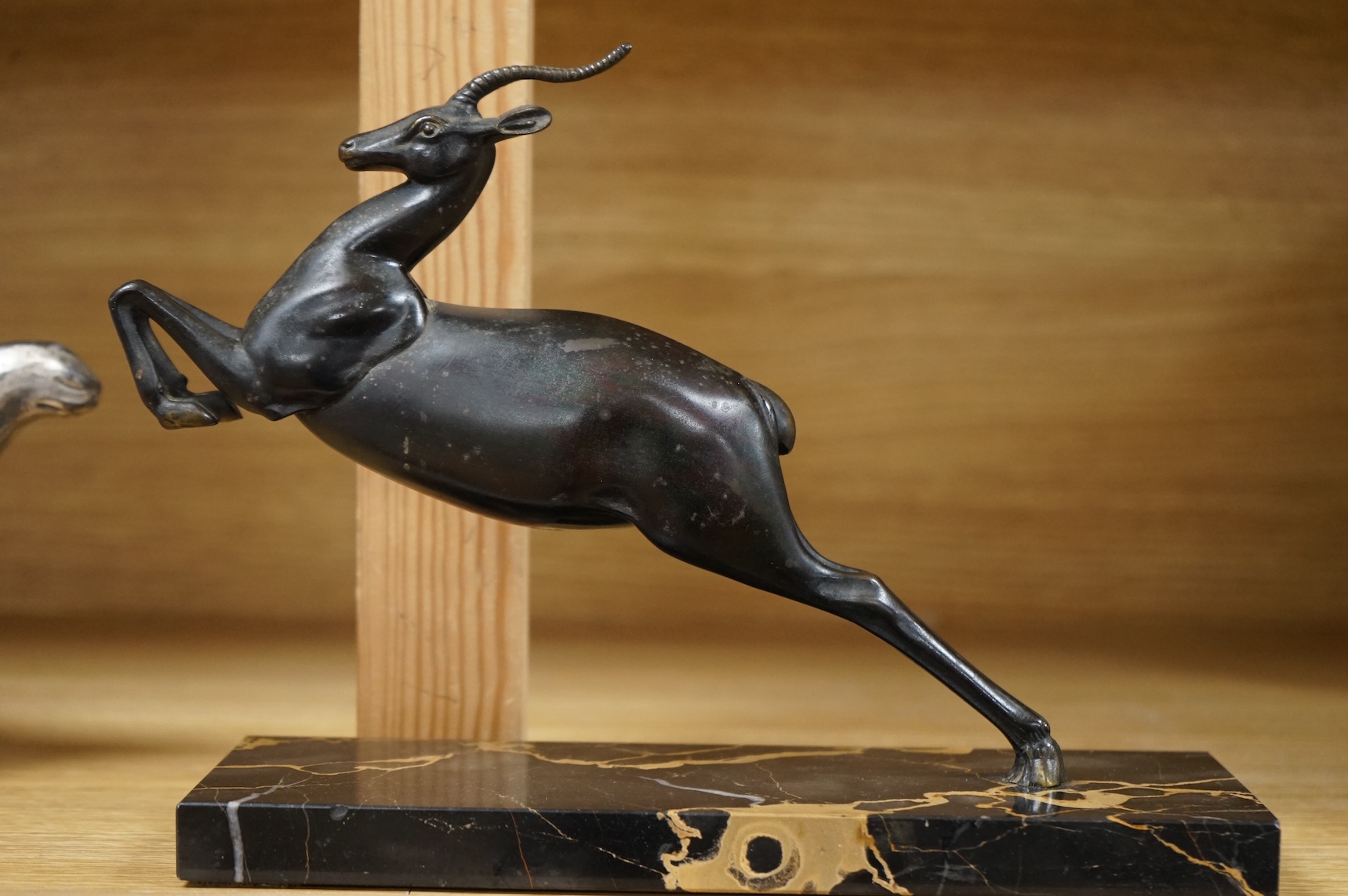 An Art Deco spelter study of a leaping gazelle, 27cm wide